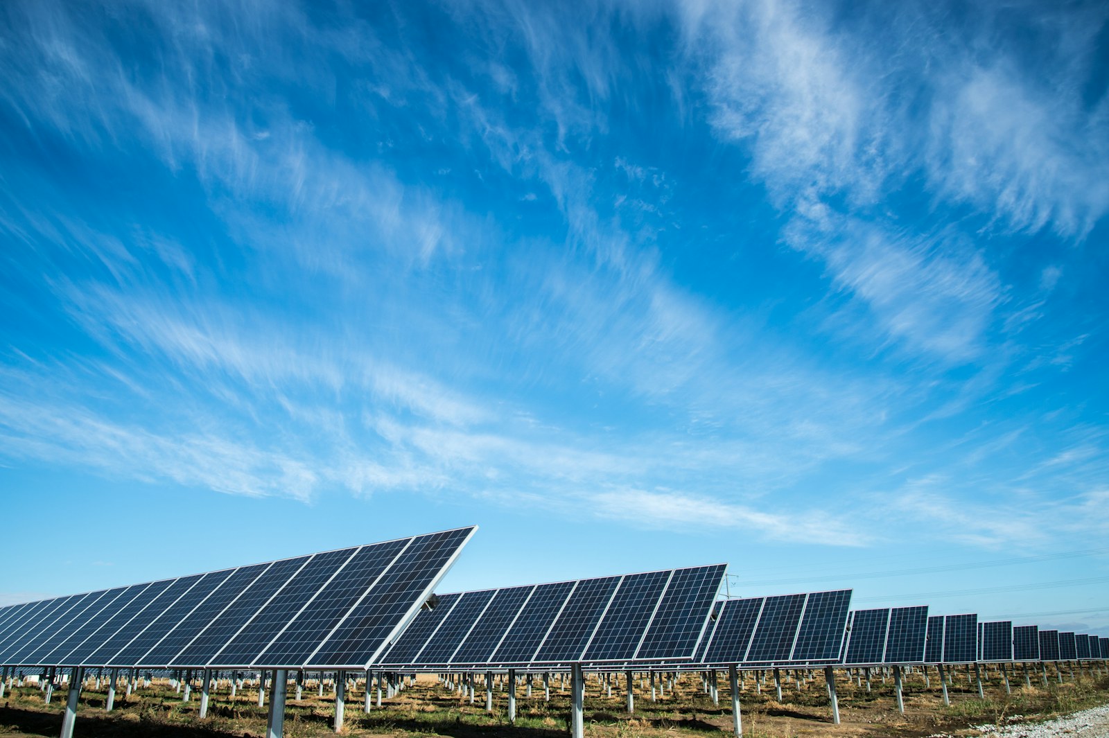 Solar panel field under a clear blue sky